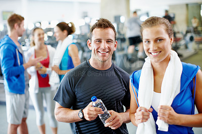 Buy stock photo Portrait of a young man and woman standing together at the gym