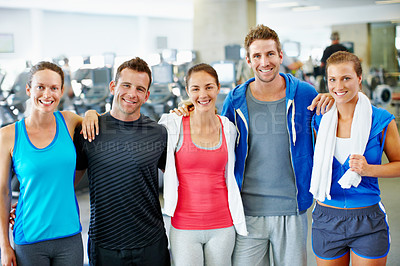 Buy stock photo Portrait of young men and women in sports clothing standing in a gym