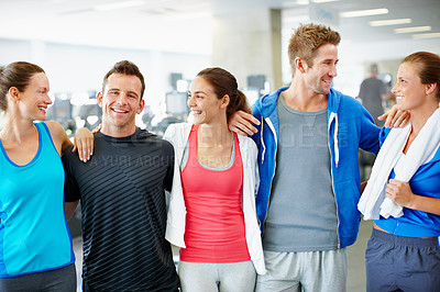 Buy stock photo Portrait of young men and women in sports clothing standing in a gym