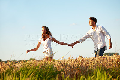 Buy stock photo Love, smile and holding hands with couple in field for connection, space and spring date. Support, happiness and marriage anniversary with man and woman in countryside for freedom and getaway