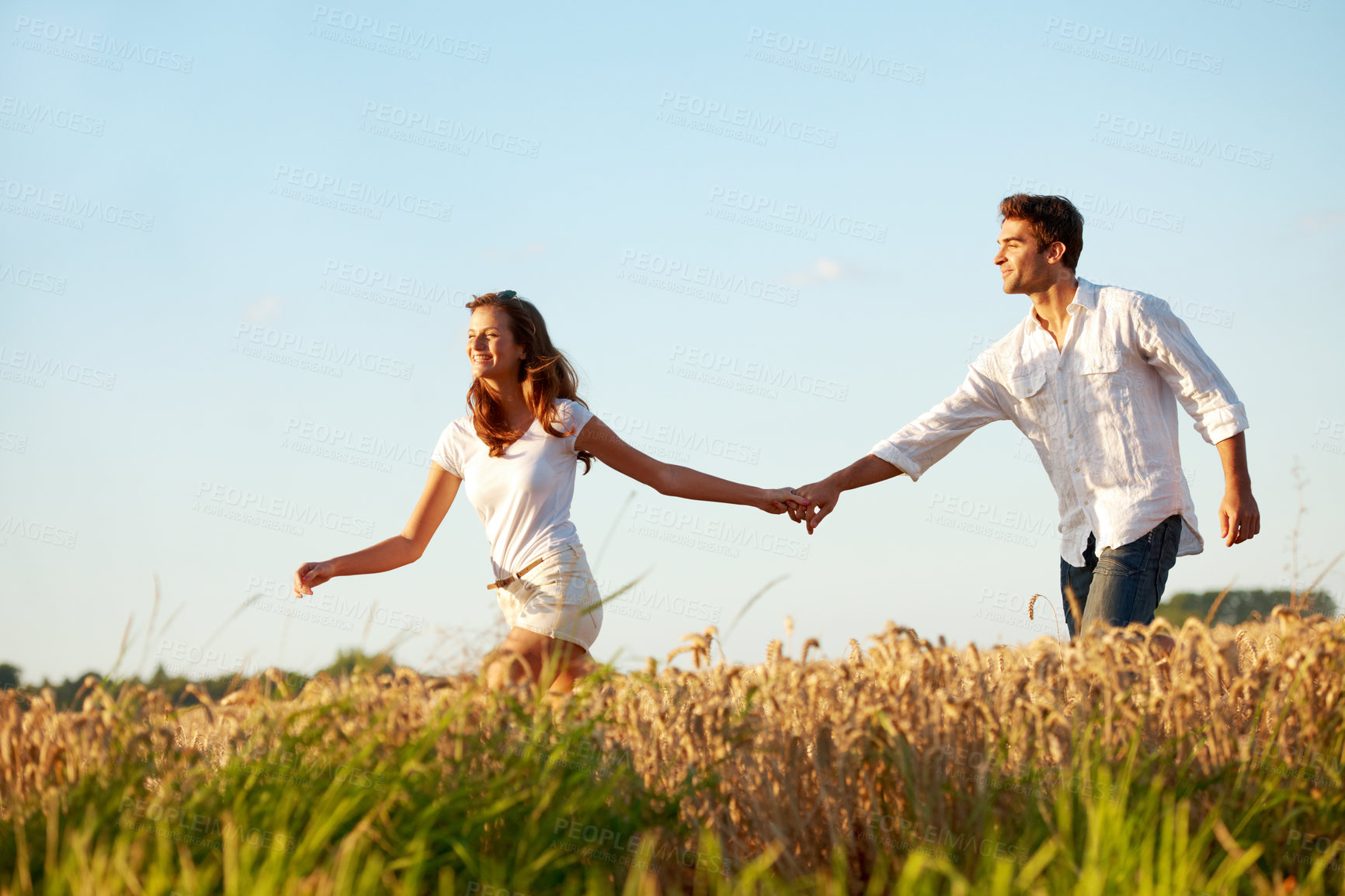 Buy stock photo Love, smile and holding hands with couple in field for connection, space and spring date. Support, happiness and marriage anniversary with man and woman in countryside for freedom and getaway