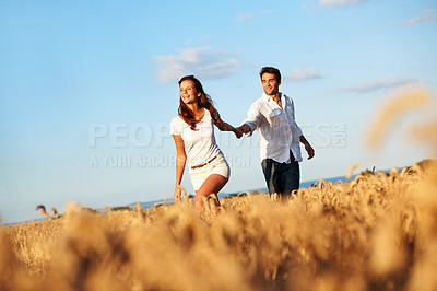 Buy stock photo Holding hands, walking and love with couple in field for honeymoon getaway, support and trust. Space, connection and date with man and woman in countryside for loyalty, holiday and travel together