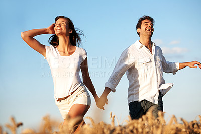 Buy stock photo Holding hands, freedom and love with couple in field for honeymoon getaway, support and trust. Care, connection and date with man and woman in countryside for loyalty, holiday and travel together