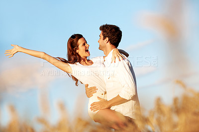 Buy stock photo Love, excited and carry with couple in field for connection, bonding and spring date together. Support, happiness and marriage anniversary with man and woman in countryside for care and getaway