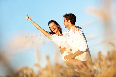 Buy stock photo Fun, hug or couple in countryside with break, happy moment or bonding on summer trip. Smile, low angle or people in field with embrace, romantic connection or playful relationship in outdoor date.