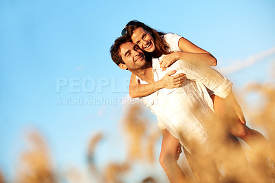 Buy stock photo Piggyback, date and love with couple in field for honeymoon getaway, support and trust. Care, connection and vacation with man and portrait of woman in countryside for loyalty, holiday and space