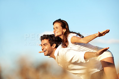 Buy stock photo Couple, laughing and piggyback in nature, sky and bonding with partner on break, playful or together. Outdoor, freedom and happy people on summer vacation, space and low angle on weekend adventure