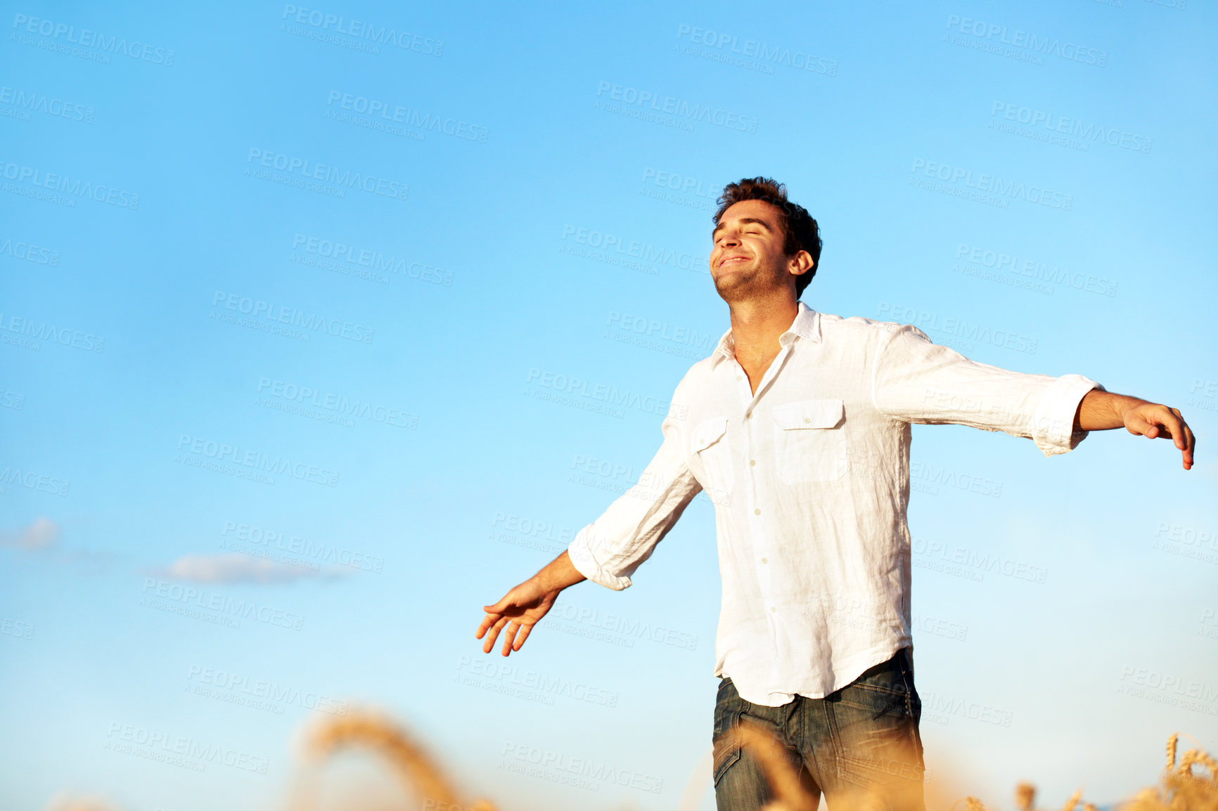 Buy stock photo Thinking, happy and man in field for freedom, gratitude and fresh air for wellness on weekend. Outdoor, smile and person with space for reflection, thoughtful and calm for peace, break and relax