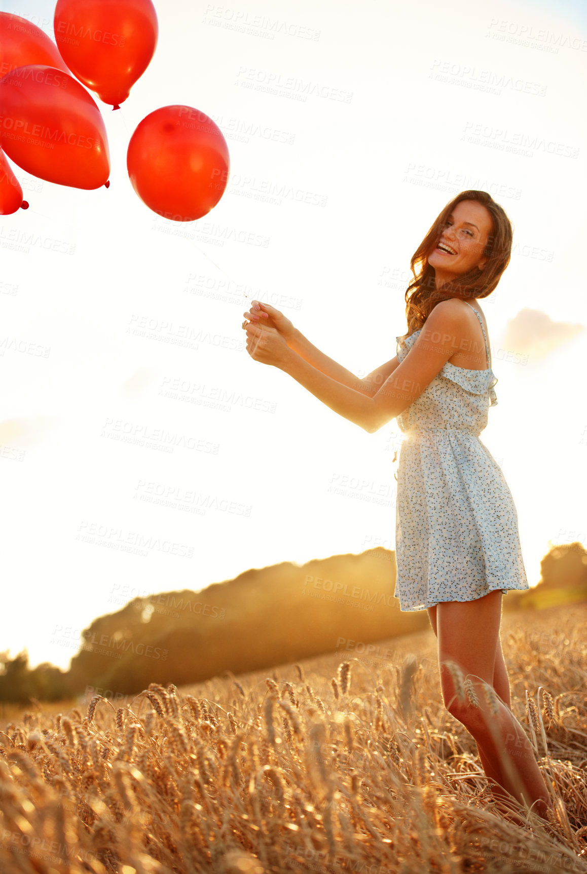 Buy stock photo Celebration, woman and laugh with balloons wheat in field for birthday trip, portrait or growth. Travel, sunshine and happy person in countryside for milestone party, weekend getaway or special event