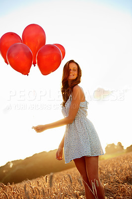 Buy stock photo Celebration, woman and smile with balloons in field for birthday getaway, portrait and growth. Travel, sunshine and person with countryside party for personal milestone, weekend trip or special event