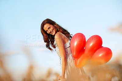 Buy stock photo Portrait, balloons and happy woman in corn field for outdoor romance, love or valentines day. Female person, smile and travel with inflatables for romantic surprise, celebration or event in nature
