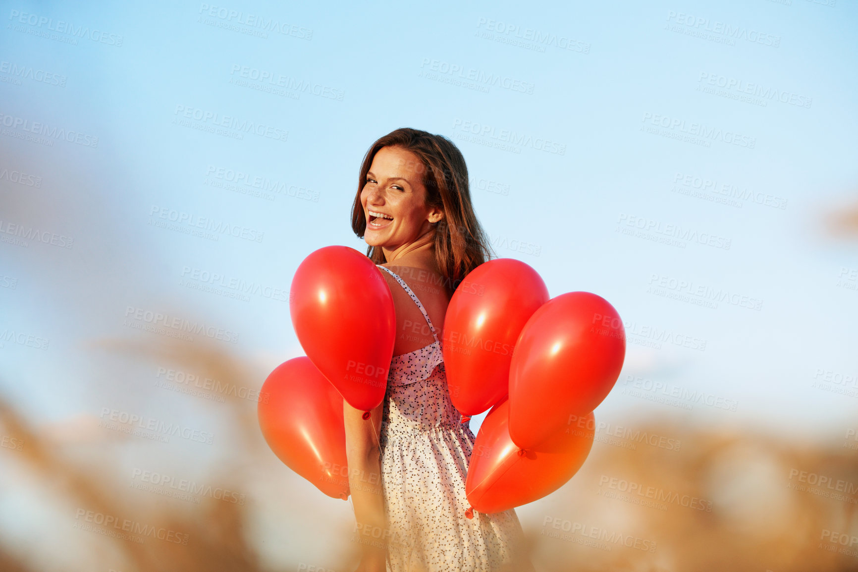 Buy stock photo Portrait, balloons and happy woman in countryside for outdoor romance, love or valentines day. Female person, smile and travel with inflatables for gift, romantic surprise or anniversary in nature