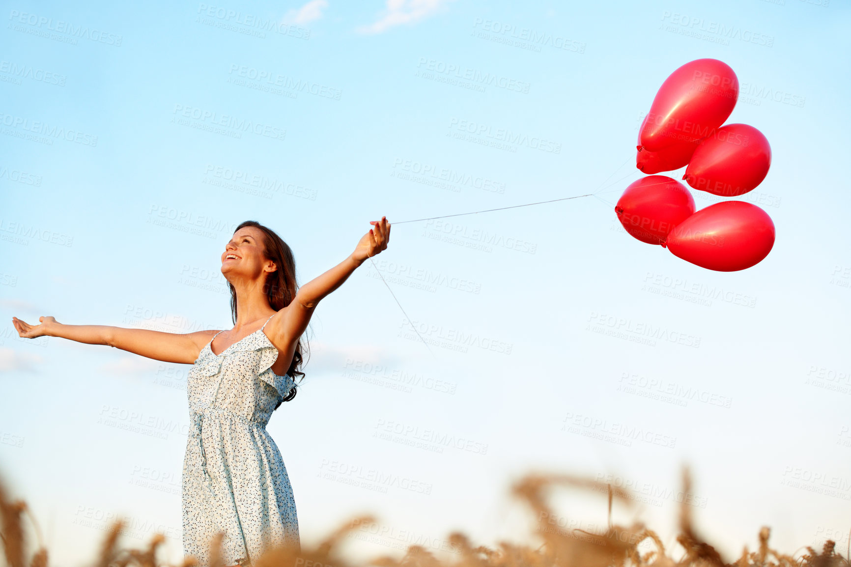Buy stock photo Fun, thinking or woman in countryside with balloons, trip celebration or mindfulness on summer break. Freedom, space or person in field with open arms, special moment or holiday mindset in nature.