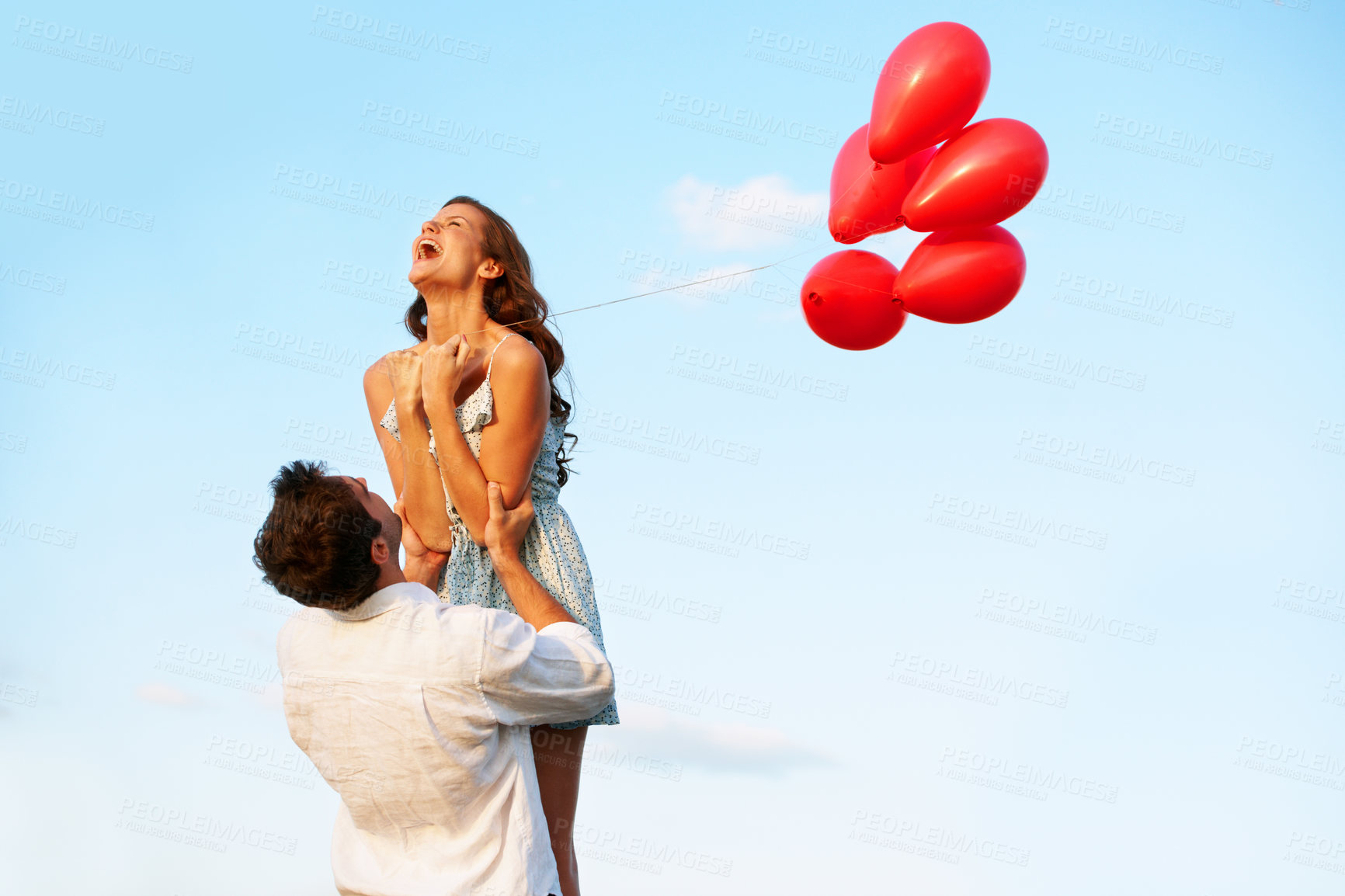 Buy stock photo Balloons, couple and lift on blue sky for vacation, bonding or excited in countryside. Freedom, happy man and woman in nature space for weekend trip with holiday, anniversary and playful celebration