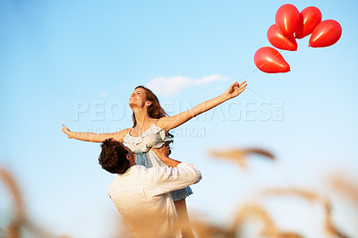 Buy stock photo Balloons, couple and lift in wheat field for vacation, bonding or romance in countryside. Freedom, man and woman in nature for weekend trip together with holiday, anniversary and playful celebration