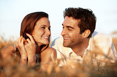 Buy stock photo Countryside, laugh and couple in field for love, bonding and connection on summer weekend. Dating, happy and man with woman in nature with funny joke for relationship, trust and relax on holiday