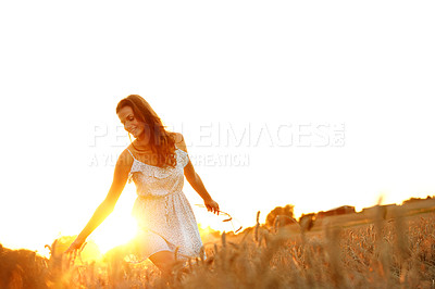Buy stock photo Travel, wheat and sunset with woman in field for explore, adventure getaway and relax in countryside. Happy, wellness and peace with person in nature for tourism, vacation and summer holiday space