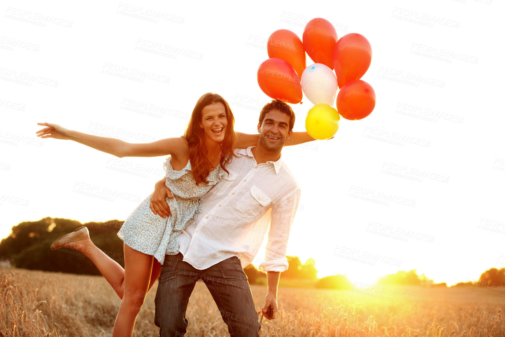 Buy stock photo Happy, portrait and couple in field with balloons for love, relationship and gift for valentines day. Sunset, countryside and man with woman with sunshine for bonding, trust and celebrate anniversary