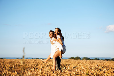 Buy stock photo Love, fun or couple in countryside with piggyback, happy partner or bonding together on summer break. Smile, space or people with carrying, romantic connection or playful moment on outdoor date.