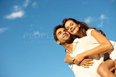 Buy stock photo Happy, couple and piggyback with blue sky for love, outdoor holiday or vacation together in nature. Low angle, man and woman with smile, hug or embrace for romance, date or weekend getaway on space