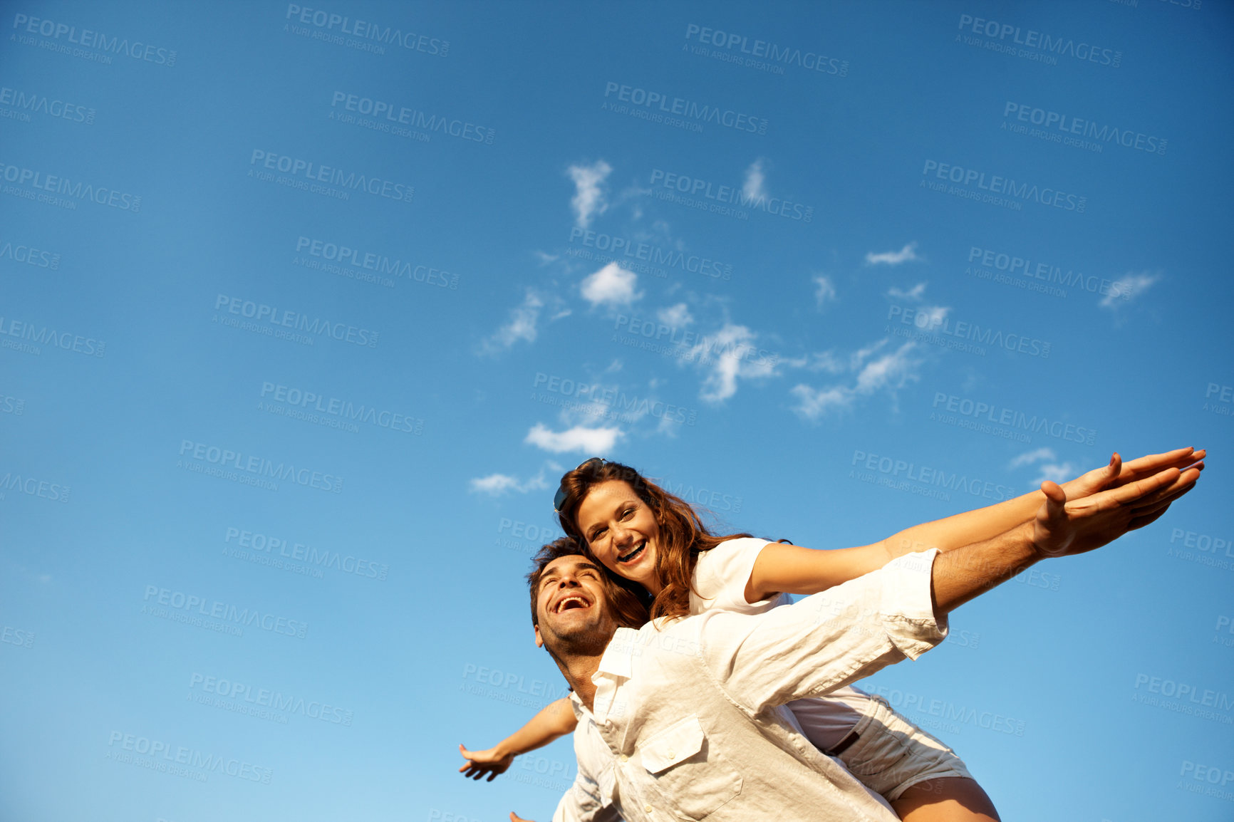 Buy stock photo Couple, flying and piggyback on holiday, sky and playful with partner on weekend, love and together. Portrait, freedom and happy people on summer vacation, mockup space and low angle on adventure