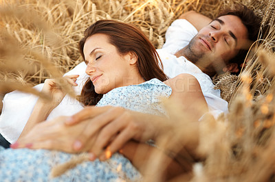 Buy stock photo Love, couple and sleep at wheat field, vacation and bonding together for healthy relationship. Nap, woman and man rest at countryside farm with partner for trust, care or relax for holiday outdoor