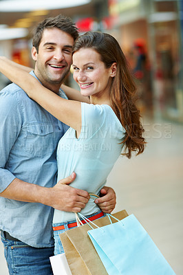 Buy stock photo Portrait, shopping and hug with couple in mall for retail promotion, boutique sales and love. Support, store deal and consumer product with man and woman for customer, happy and discount service