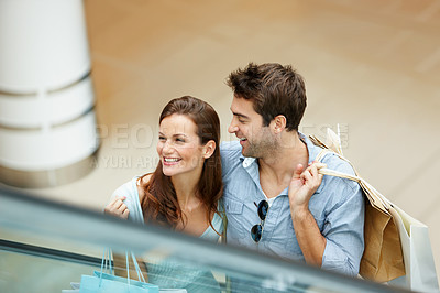 Buy stock photo Retail, shopping and escalator with couple in mall for purchase, anniversary gift and support. Store discount, customer promotion and love with man and woman with bags for boutique shopper and smile