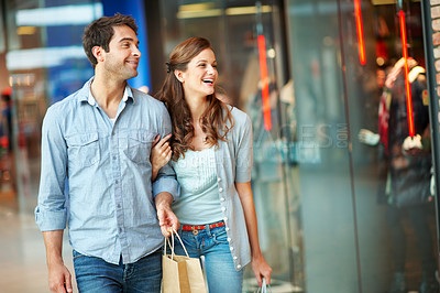 Buy stock photo Happy, shopping and window with couple in mall for retail promotion, boutique sales and love. Support, store deal and consumer product with man and woman with bags for customer, smile and discount