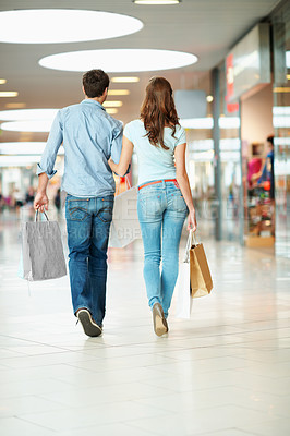 Buy stock photo Back, shopping and walk with couple in mall for retail purchase, anniversary gift and support. Store discount, customer promotion and love with man and woman with bags for boutique shopper and sale