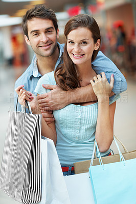 Buy stock photo Portrait, couple and hug in mall with shopping bag, fashion sale and bonding together on weekend break. Happy, people dating and embrace with retail purchase, cashback promotion and clothes discount.