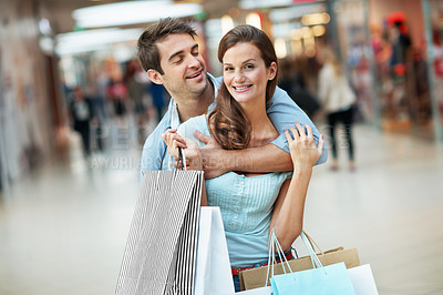 Buy stock photo Smile, shopping and hug with couple in mall for retail promotion, boutique sales and love. Support, store deal and consumer product with man and portrait of woman for customer, happy and discount