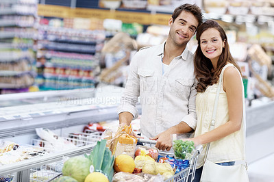 Buy stock photo Walking, portrait and happy couple with cart in grocery store, supermarket and shopping on weekend. Smile, dating and man with woman with products, food and produce for discount, sale and bonding
