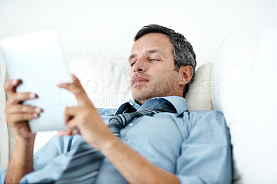 Buy stock photo Tablet, relax and businessman on sofa in home with remote work for finance report with email feedback. Digital technology, reading and male financial manager with review on investment plan in house.