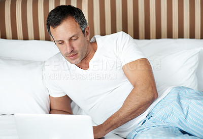 Buy stock photo Bed, man and scroll on laptop in morning for reading global news, market tracking and remote work. Freelance trader, mature person and tech in home for economic calendar, stocks account and research