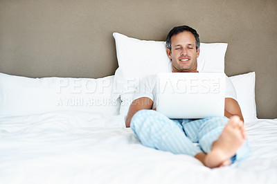 Buy stock photo Relax, man and smile with laptop on bed for binge watching series, movie and peaceful morning. Space, mature person or tech in bedroom for streaming film, tv show or comfortable weekend break in home