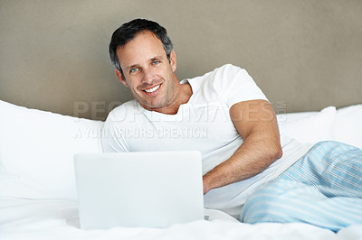 Buy stock photo Smile, man and relax with laptop on bed for global stocks news, trading and remote work. Freelance trader, mature person and tech in home for market research, morning portrait or portfolio management