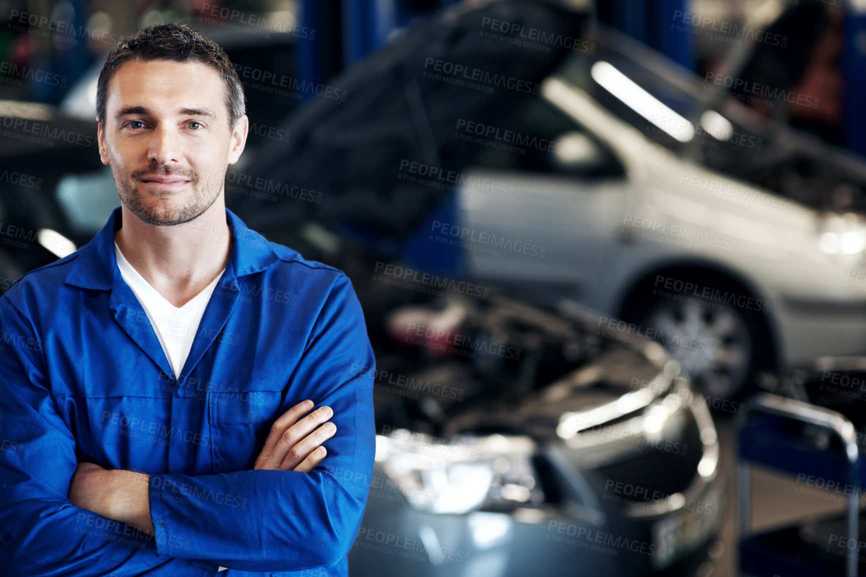 Buy stock photo Crossed arms, smile and portrait of mechanic in workshop with confidence for repairs on car. Man, professional and automotive technician with pride for vehicle maintenance at garage in London.
