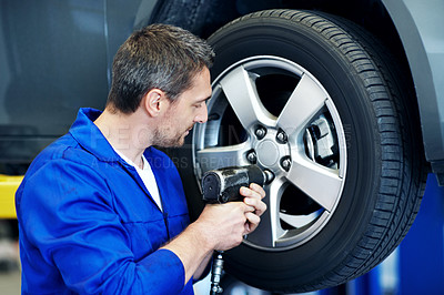 Buy stock photo Workshop, mechanic and man with drill for tire alignment, repair and maintenance for auto service. Garage, technician and person with equipment for fixing, installation and inspection for vehicle
