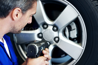 Buy stock photo Garage, mechanic and man with drill for tire installation, repair and maintenance for auto service. Workshop, technician and person with equipment for fixing, calibration and inspection for vehicle