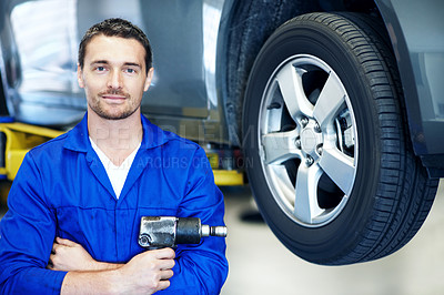 Buy stock photo Portrait, man and mechanic in garage with drill, smile and wheel alignment for engineering career. Tools, confident and workshop for car repair, maintenance and tire or vehicle service specialist