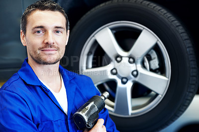 Buy stock photo Portrait, man and mechanic in workshop with drill, smile and wheel alignment for engineering career. Tools, confident and garage for car repair, maintenance and tire or vehicle service specialist