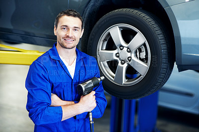 Buy stock photo Mechanic, portrait and wheel with man in garage for automobile maintenance or repair. Impact wrench, service and transportation with engineer in vehicle workshop for professional check or inspection