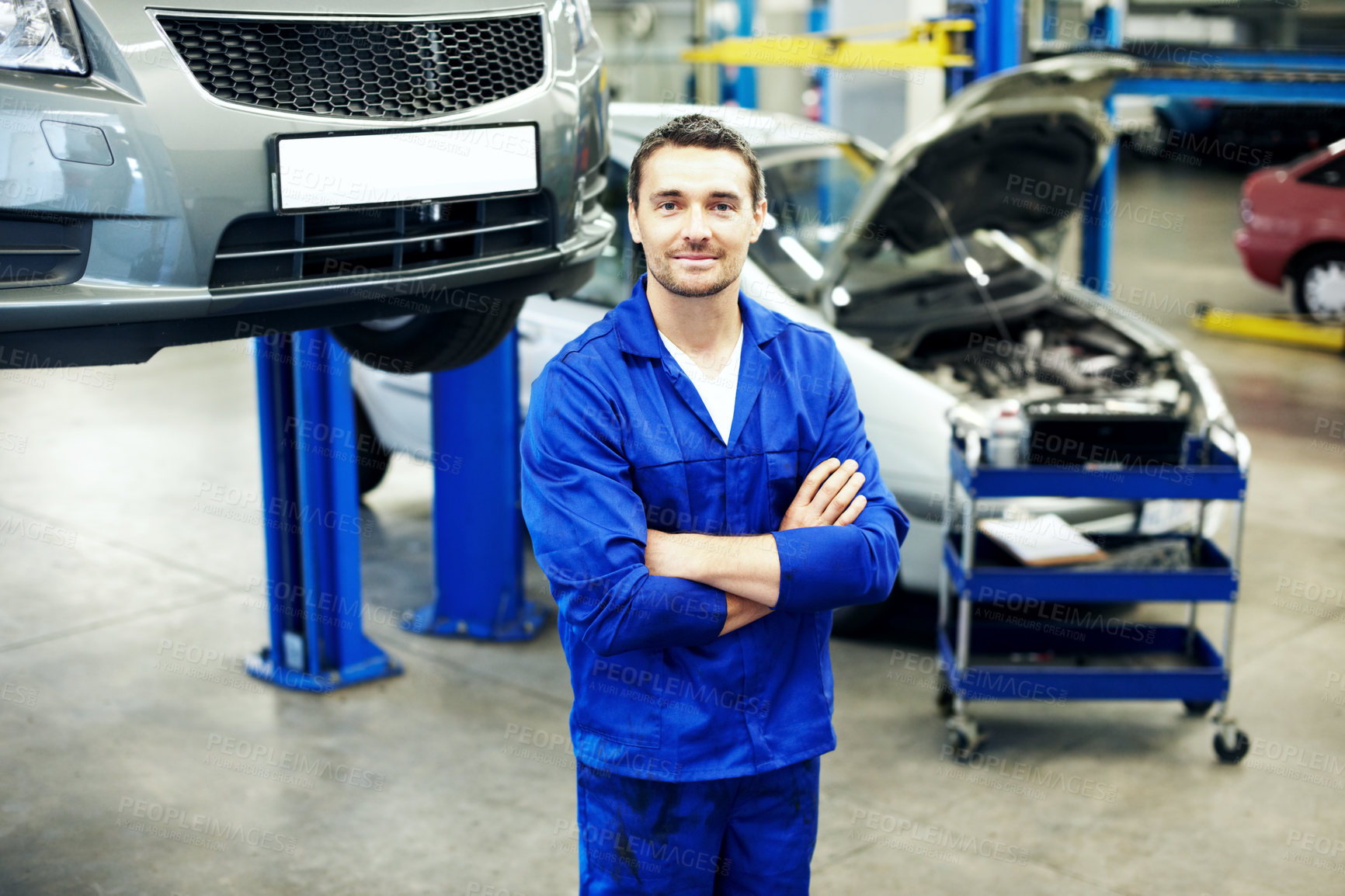 Buy stock photo Repair, arms crossed or car mechanic in workshop with portrait, ambition or about us as motor technician. Smile, man or auto engineer with uniform, confidence or pride in vehicle maintenance.