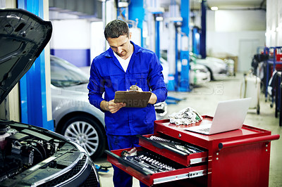 Buy stock photo Man, writing and car mechanic in workshop with clipboard, engine inspection and maintenance service. Technician, person and notes in garage with checklist, vehicle evaluation and motor assessment.