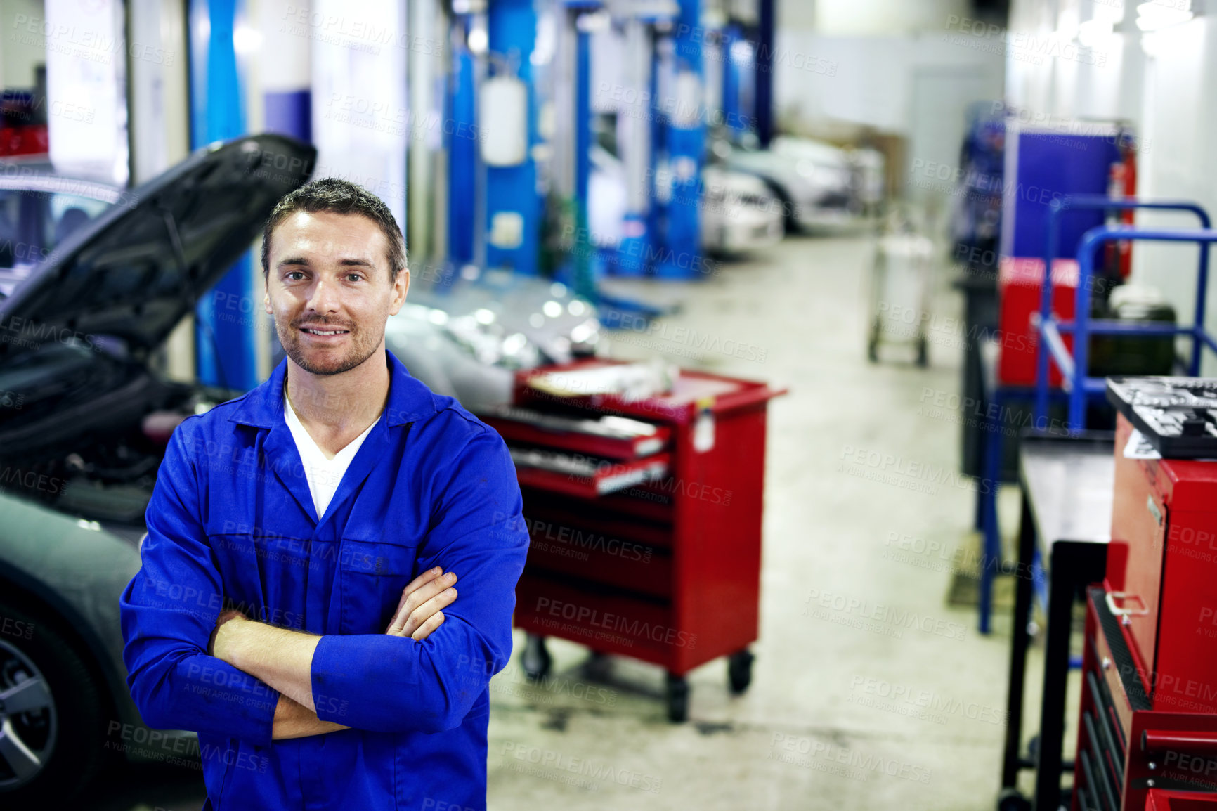 Buy stock photo Smile, mechanic and man with arms crossed in workshop, inspection and service for vehicle repair. Portrait, male person or leadership in garage with technician, automotive maintenance and diagnostics
