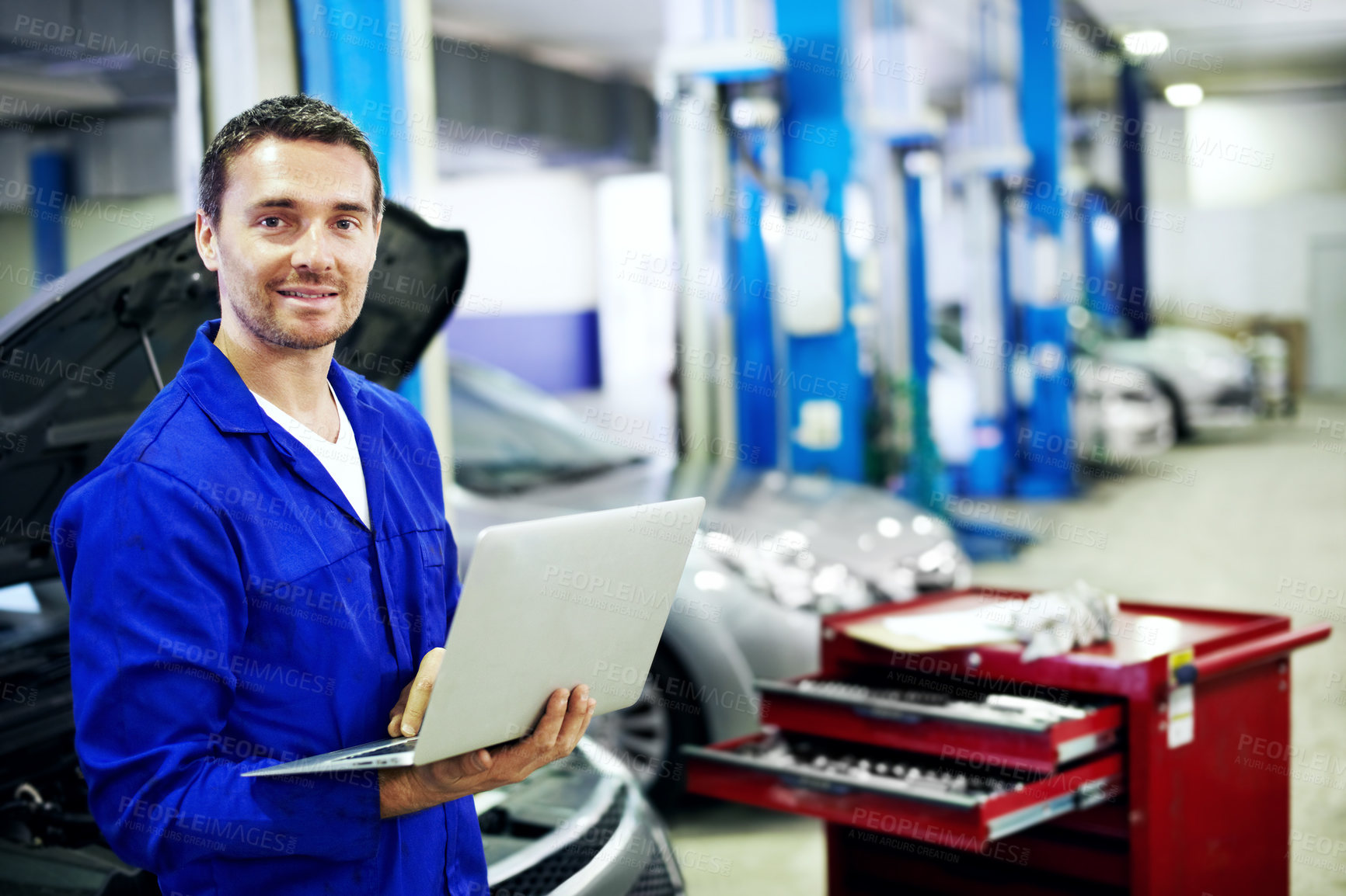 Buy stock photo Portrait, man and mechanic in workshop with laptop, smile and software for engineering career. Happy, technology and garage for car diagnostics, maintenance and auto or vehicle service or tuning