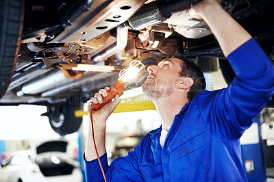 Buy stock photo Car, lamp and undercarriage with man in garage for vehicle inspection, repair or service. Fix, light and maintenance with mechanic in automobile workshop for check, compliance or engineering job