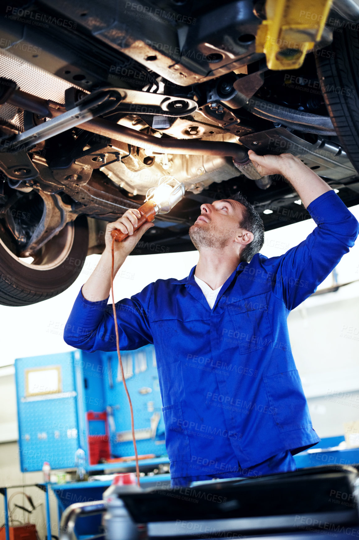 Buy stock photo Fix, lamp and maintenance with man in garage for vehicle inspection, repair or service. Car, light and undercarriage with mechanic in automobile workshop for check, compliance or engineering job