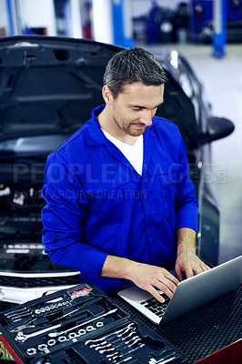 Buy stock photo Man, laptop and car mechanic in workshop with repair, typing quote and cost of maintenance service. Technician, person and research in startup with computer, fix vehicle and report expenses for job.